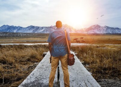 shallow-focus-from-male-standing-pathway-middle-grassy-field